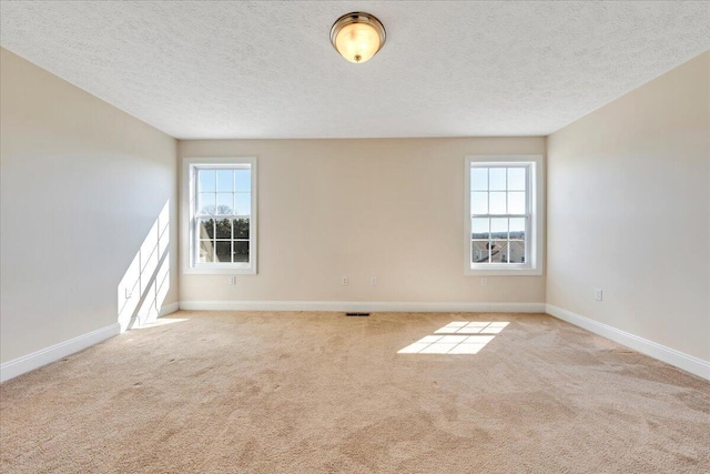 unfurnished room with baseboards, plenty of natural light, and carpet flooring