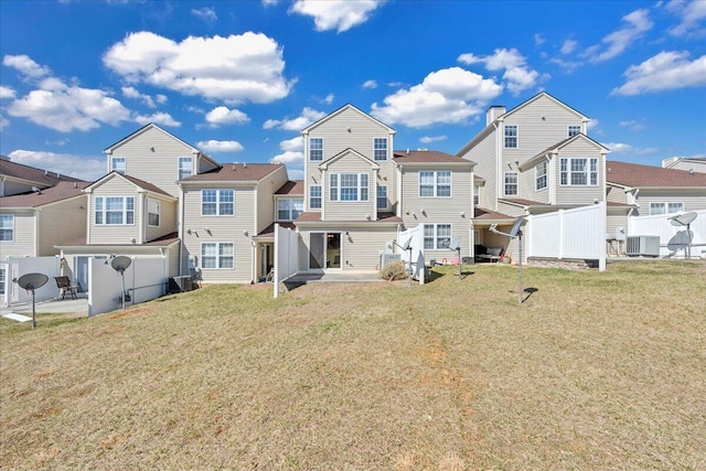 back of property with central air condition unit, fence, a patio area, and a residential view