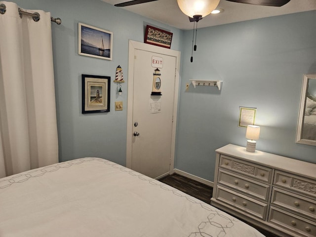 bedroom with baseboards, ceiling fan, and dark wood finished floors