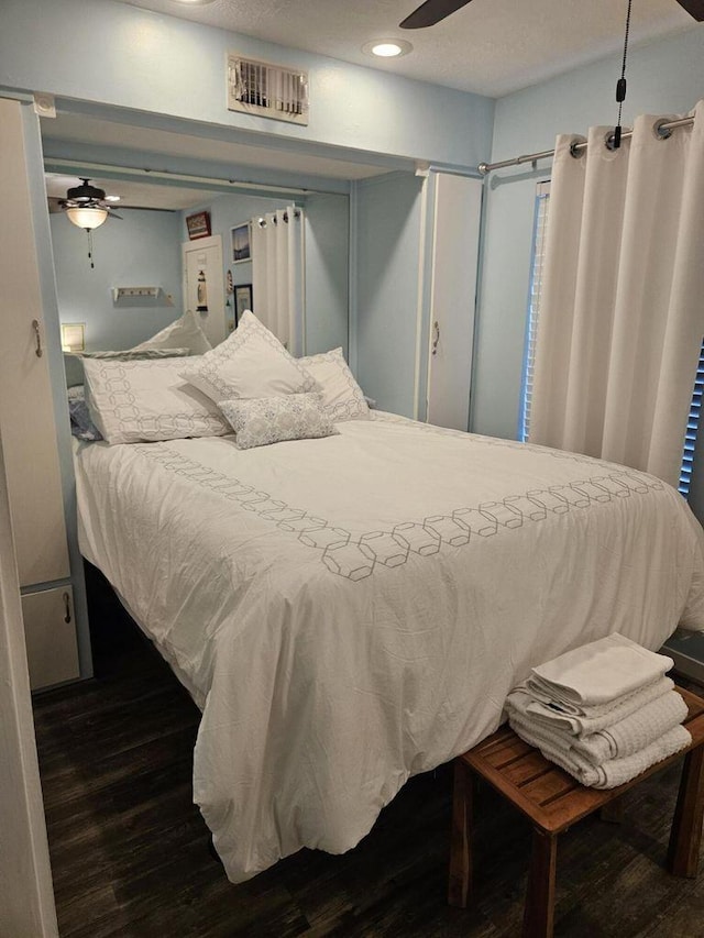 bedroom featuring recessed lighting, visible vents, and dark wood-type flooring