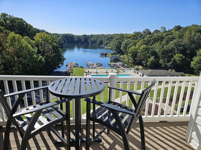 balcony with a water view and a wooded view