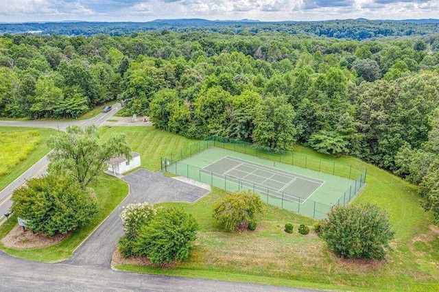 birds eye view of property with a wooded view