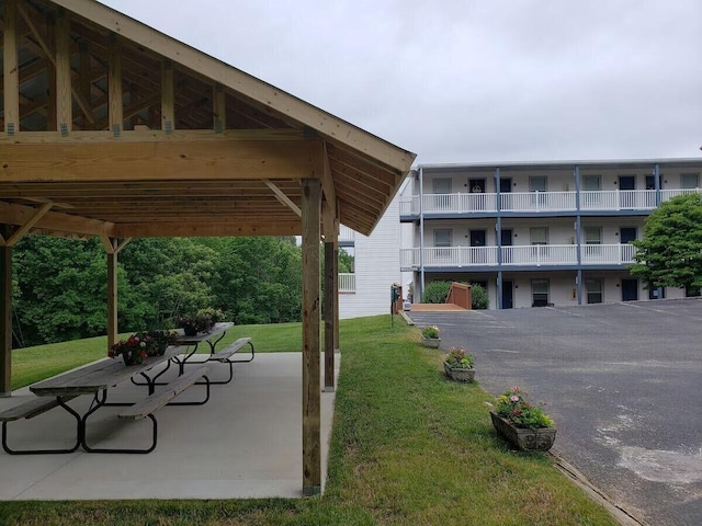 view of home's community with a yard and a patio area