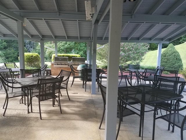 view of patio / terrace with exterior kitchen, grilling area, and outdoor dining space