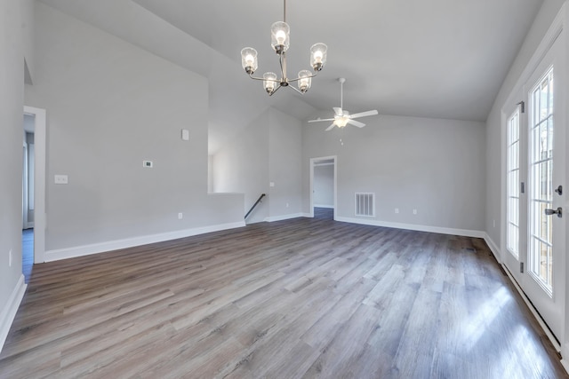 interior space featuring lofted ceiling, a healthy amount of sunlight, visible vents, and wood finished floors