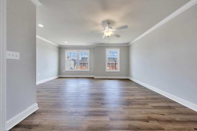 empty room featuring ornamental molding, dark wood-type flooring, recessed lighting, a ceiling fan, and baseboards