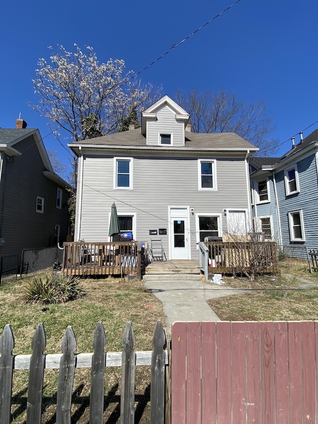 view of front of property featuring a fenced front yard and a deck