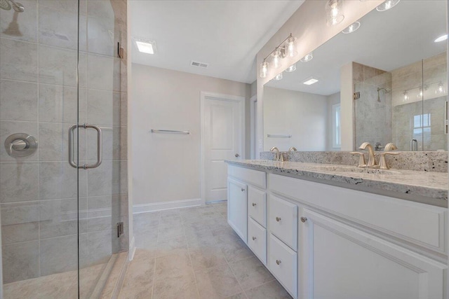 full bathroom with visible vents, a sink, a shower stall, and double vanity