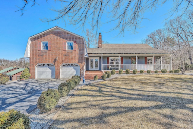 split level home with driveway, a garage, a chimney, french doors, and a porch