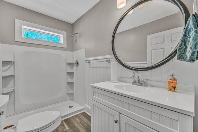 full bathroom with wood finished floors, vanity, toilet, and walk in shower