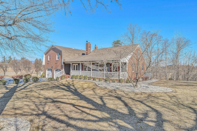 view of front facade featuring covered porch, a shingled roof, a gambrel roof, a chimney, and a front yard