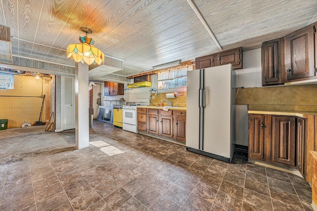 kitchen featuring white appliances, wood ceiling, wall chimney exhaust hood, light countertops, and a sink