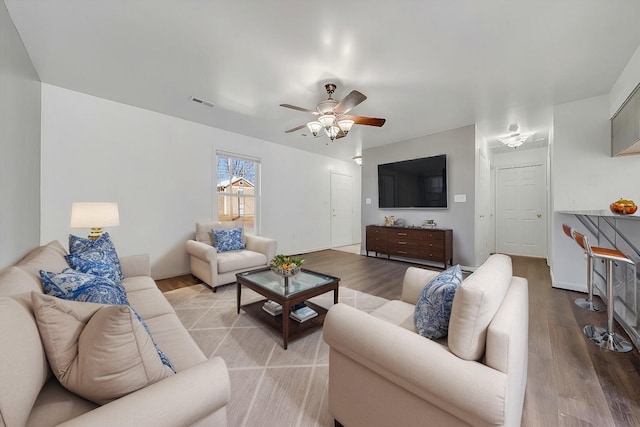 living room featuring ceiling fan and wood finished floors