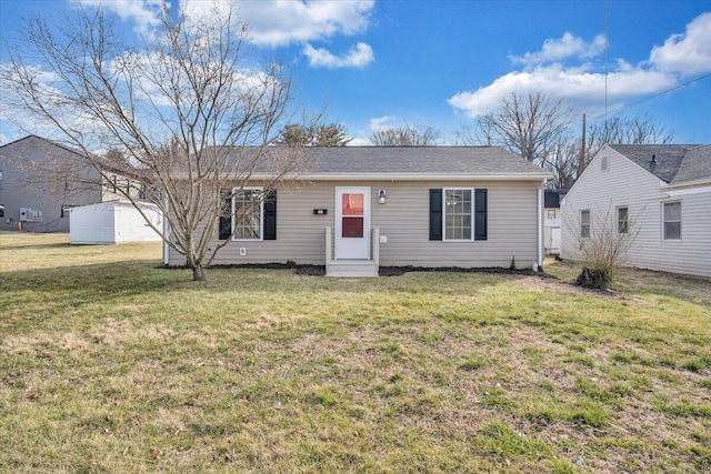 ranch-style home with entry steps and a front lawn