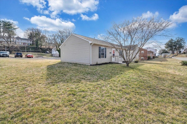 view of side of property with a yard