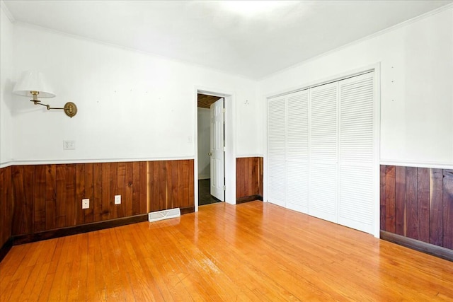 2351 Reese Mountain Rd, Elliston, VA 24087 - unfurnished bedroom featuring a closet, a wainscoted wall, hardwood / wood-style flooring, and visible vents