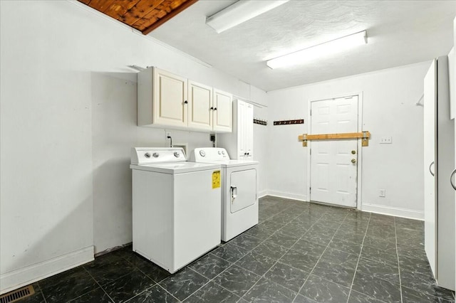 2351 Reese Mountain Rd, Elliston, VA 24087 - clothes washing area with separate washer and dryer, baseboards, visible vents, and cabinet space