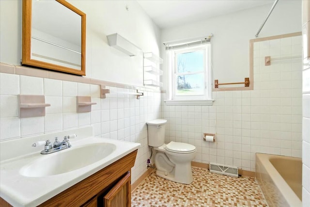 2351 Reese Mountain Rd, Elliston, VA 24087 - bathroom with a wainscoted wall, visible vents, toilet, vanity, and tile walls