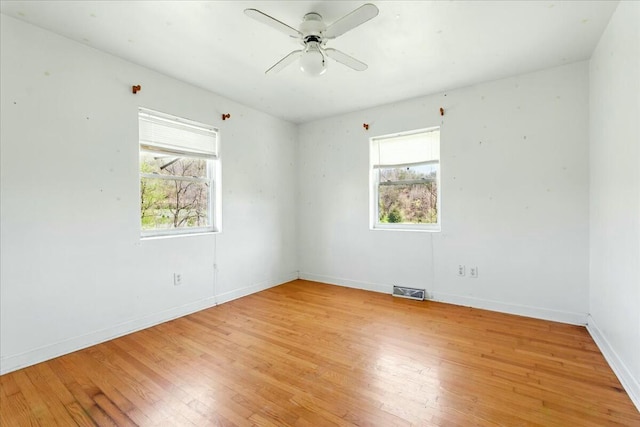 2351 Reese Mountain Rd, Elliston, VA 24087 - empty room with light wood finished floors, plenty of natural light, baseboards, and ceiling fan