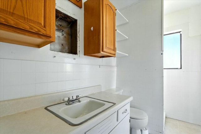 2351 Reese Mountain Rd, Elliston, VA 24087 - bathroom with tile patterned floors, decorative backsplash, vanity, tile walls, and toilet