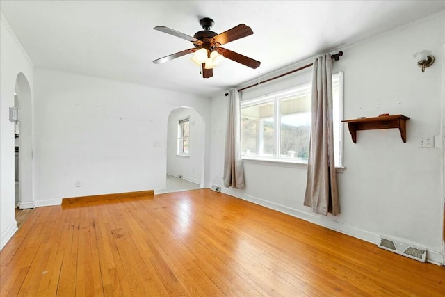 2351 Reese Mountain Rd, Elliston, VA 24087 - unfurnished room featuring arched walkways, light wood-style flooring, visible vents, and ceiling fan