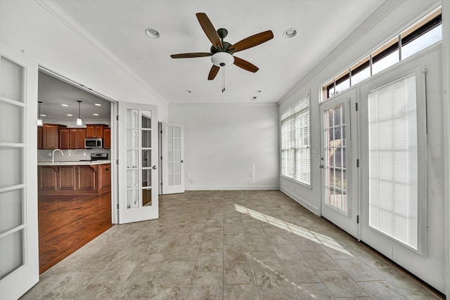 interior space with recessed lighting, french doors, crown molding, and baseboards