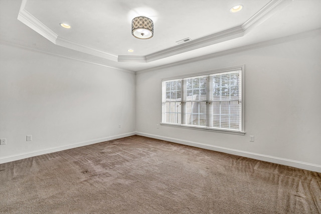 carpeted empty room featuring baseboards, visible vents, a raised ceiling, crown molding, and recessed lighting