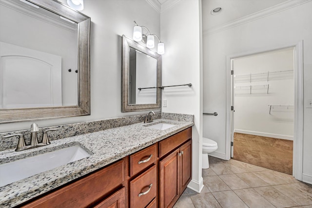 full bathroom featuring double vanity, a sink, toilet, and crown molding