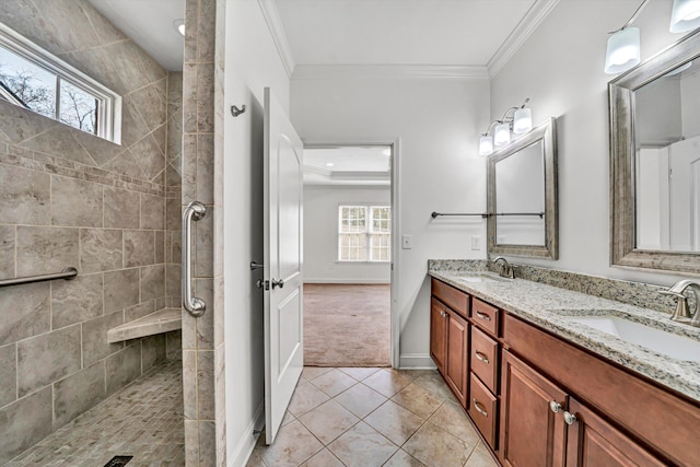 bathroom featuring ornamental molding, a sink, and a tile shower