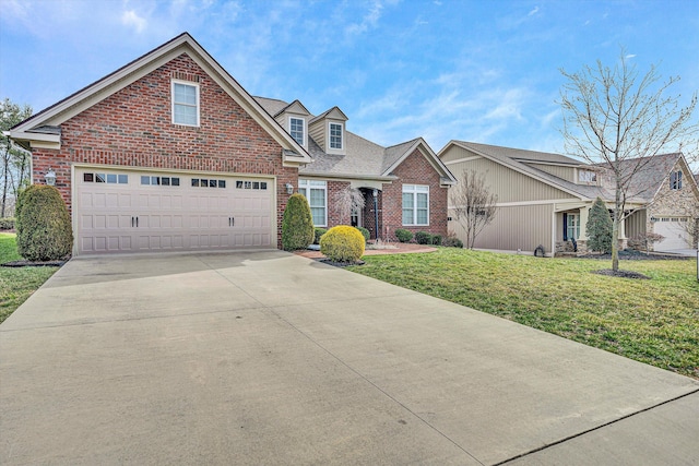 view of front of home featuring a garage, a front yard, concrete driveway, and brick siding