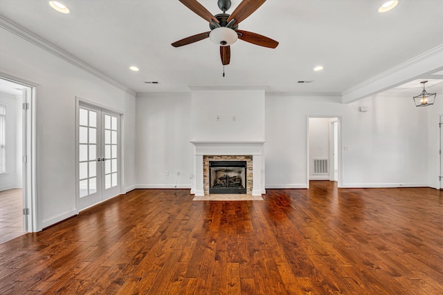 unfurnished living room featuring ornamental molding, french doors, a fireplace, and visible vents