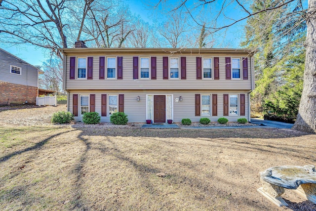 colonial-style house with a chimney