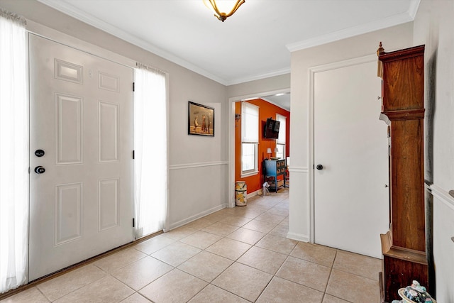 entryway featuring light tile patterned flooring, crown molding, and baseboards