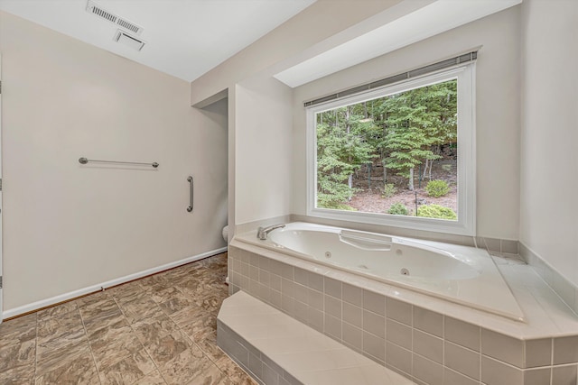 5653 Orchard Valley Cir, Roanoke, VA 24018 - full bath with a jetted tub, toilet, and baseboards