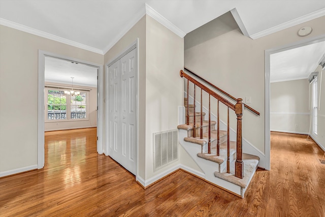 5653 Orchard Valley Cir, Roanoke, VA 24018 - staircase with wood finished floors, crown molding, a chandelier, and baseboards
