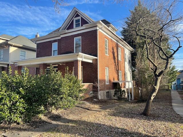 view of side of home featuring brick siding