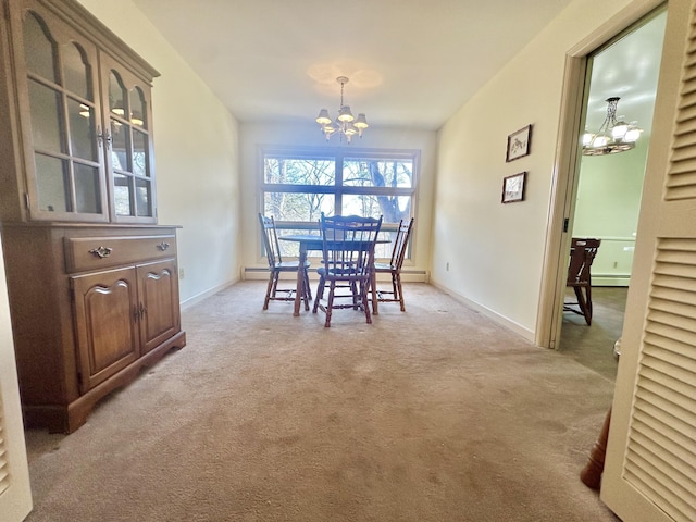 dining room featuring a baseboard radiator, light carpet, baseboards, and an inviting chandelier