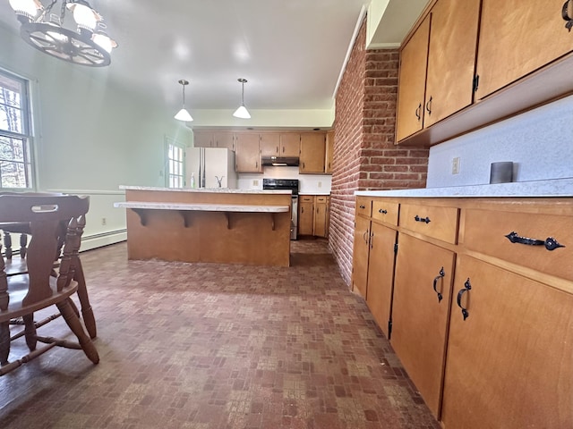 kitchen with range, a baseboard radiator, freestanding refrigerator, light countertops, and under cabinet range hood