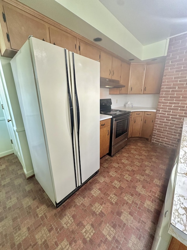 kitchen with freestanding refrigerator, stainless steel electric range, light countertops, under cabinet range hood, and brick patterned floor