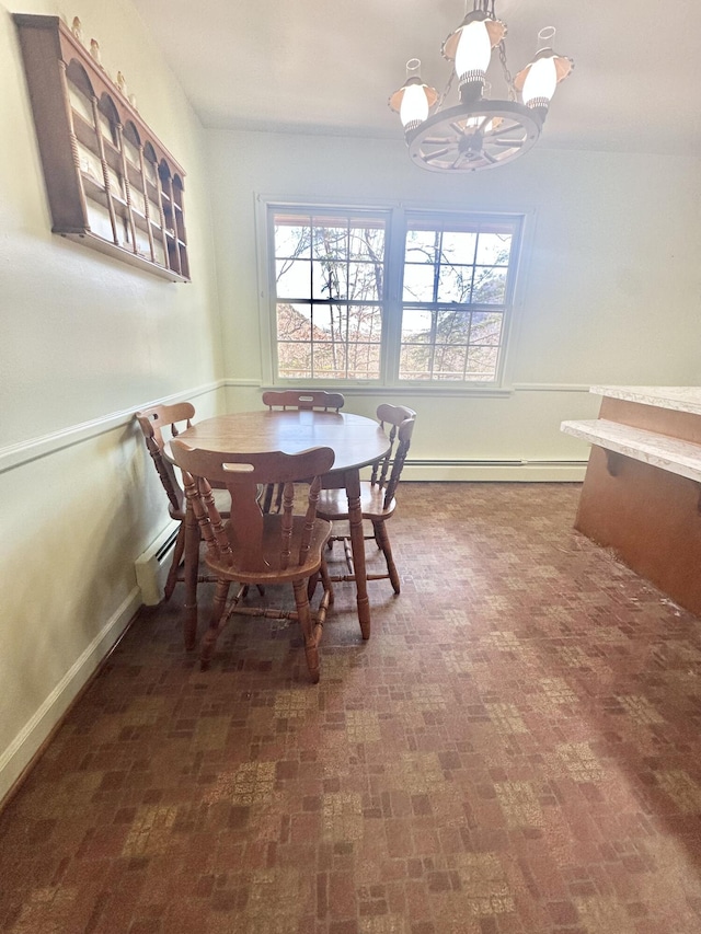 dining space with brick floor, a notable chandelier, a baseboard radiator, a baseboard heating unit, and baseboards