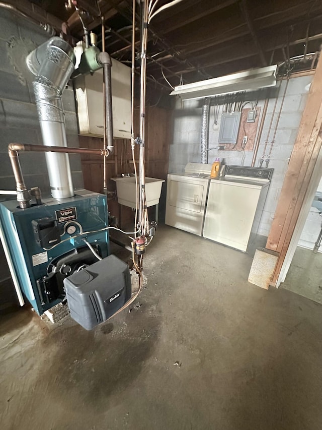 utility room featuring separate washer and dryer and a sink