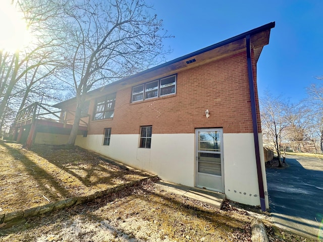 view of property exterior featuring brick siding