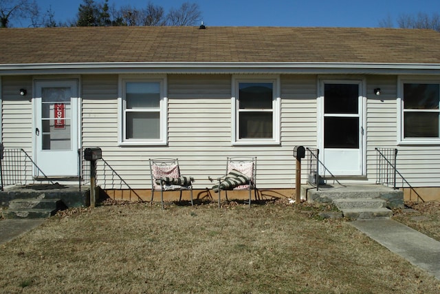 exterior space featuring roof with shingles