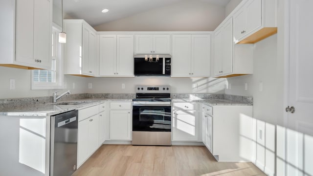 2809 Russlen Dr, Salem, VA 24153 - kitchen featuring appliances with stainless steel finishes, a sink, light stone countertops, light wood-type flooring, and lofted ceiling