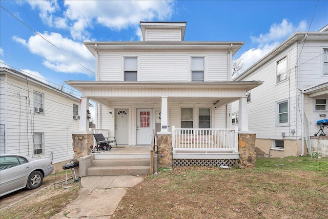 american foursquare style home featuring covered porch