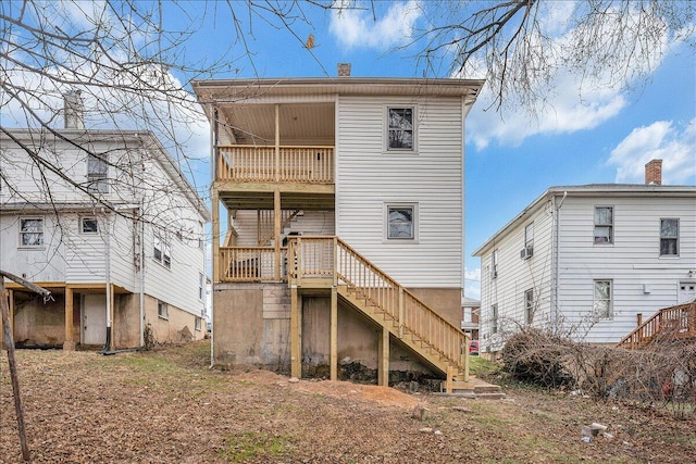 back of house featuring stairway and a balcony