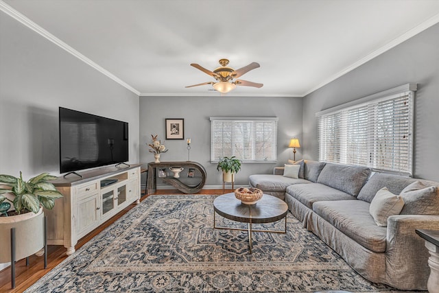 living room with wood finished floors, a ceiling fan, and ornamental molding