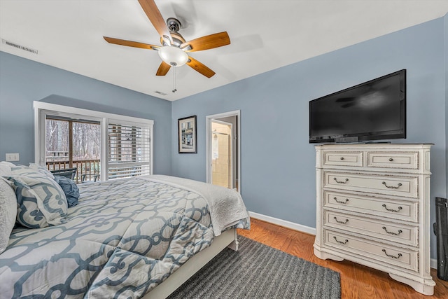 bedroom featuring access to exterior, visible vents, baseboards, wood finished floors, and a ceiling fan