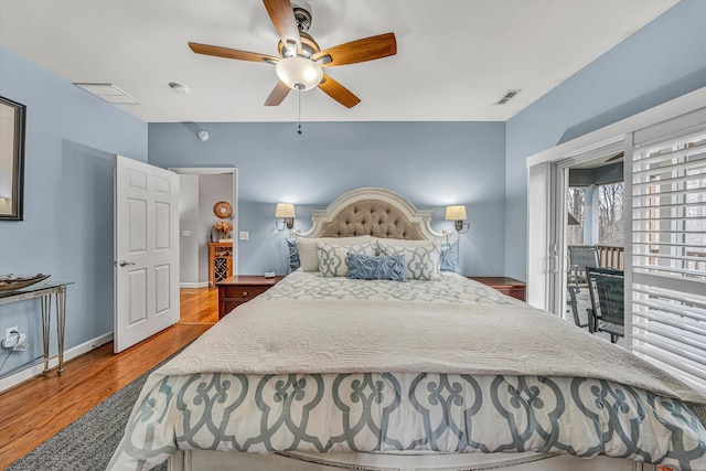 bedroom with ceiling fan, visible vents, baseboards, and wood finished floors