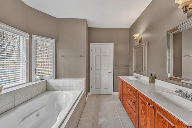 full bathroom with tile patterned flooring, a whirlpool tub, double vanity, and a sink